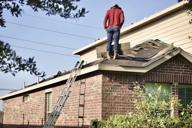 Professional roofer working on a residential roof in Woods Corner